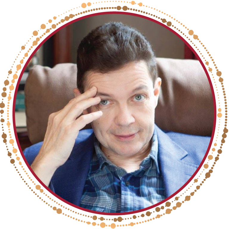 A man sitting in a chair, deep in thought with his hand on his head.